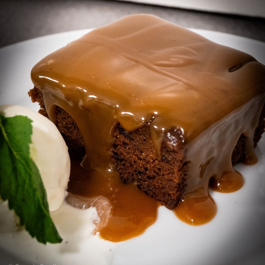 Sticky toffee pudding with toffee sauce and a scoop of ice cream